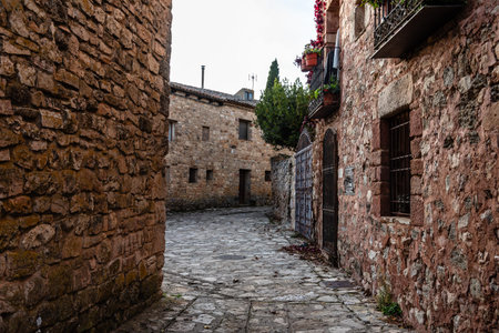 Medinaceli, Soria. Traditional stone house with terracotta roof tiles along a cobblestone street. Medieval villageの写真素材