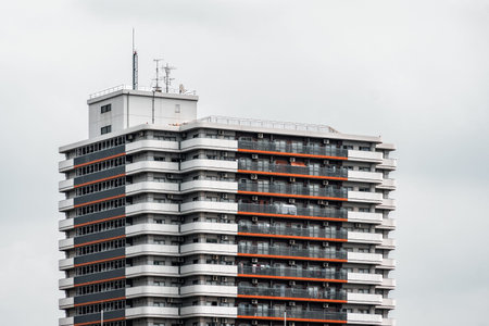 Tokyo, Japan - August 6, 2024: Modern apartment building in Sumida City, Tokyo, with a cloudy sky...