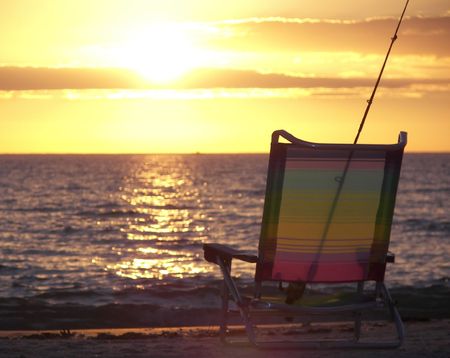 fishing pole and beach chair at florida susnetの写真素材