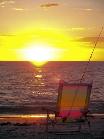 beach chair and fishing pole at florida beachの写真素材