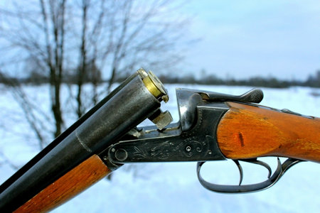 Hunting rifle on a snowy field in winter. Close-up.の写真素材