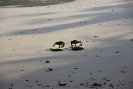 Pair of sandals on the beach in Thailand, South East Asiaの写真素材