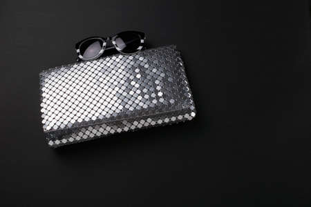 Elegant women envelope bag with silver metallic sequins and fancy sunglassesの写真素材