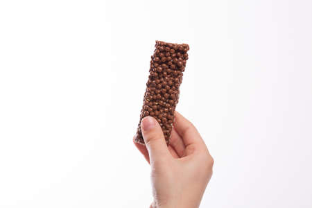 Boy hand holding a chocolate cereal bar