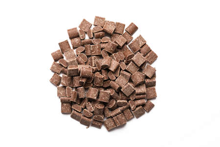 Chocolate chips for hot chocolate preparation or dessert ingredients. Heap of cocoa milk chocolate...
