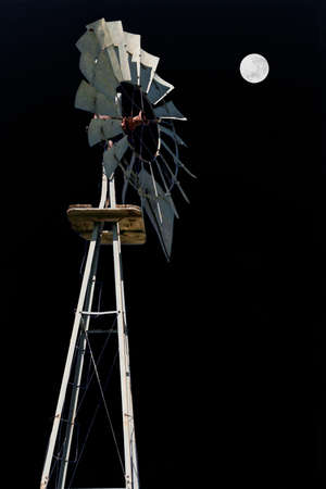 Windmill, full moon and deep black skyの写真素材