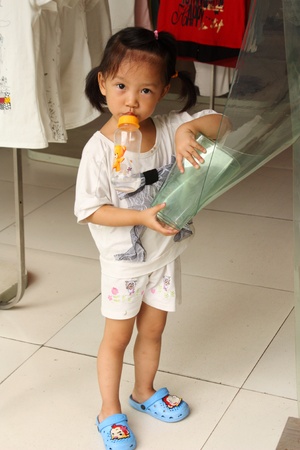Small Chinese shop girl - Chongqing store, China, August 1, 2010のeditorial素材