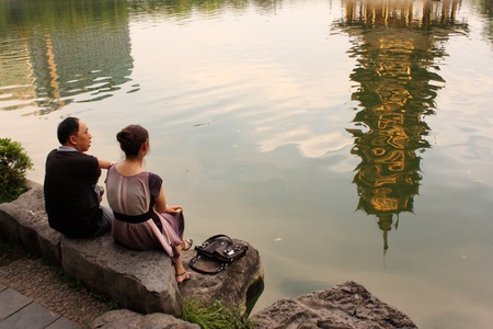 Couple at the lake, park of Two Pagodas in Guiling, China - August 1, 2010のeditorial素材