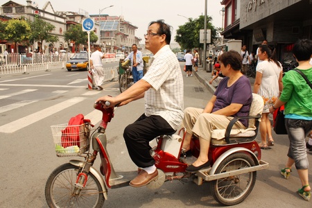 Motorbike driver and passenger in Beijing, China - July 17, 2010のeditorial素材