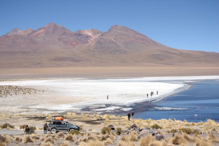 People in the lagoon in Atacama Desert in Uyuni, Bolivia, Andes - 18.09.2013のeditorial素材