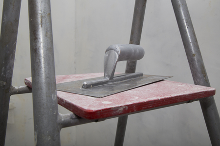 Float for applying putty at the concrete walls at the ladder during the renovation of an apartmentの写真素材