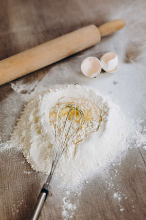 Flour and egg. Preparation for making dough. Cooking concept.の写真素材