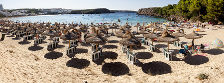 Menorca, Spain-August 27, 2015: Panoramic views of a beach full of people and Sunshades in summerのeditorial素材