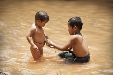 Luang Nam Tha,Laos-July 7, 2009: Children playing in the river in a Khamu town in the north of Laos near to Luand Nam Thaのeditorial素材