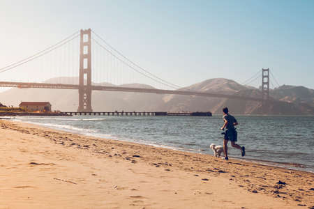 San Francisco, USA- June 22, 2017: Running and playing in San Francisco bay with his petのeditorial素材