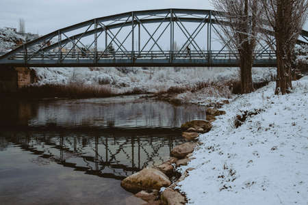 Valderrobres, Spain-January 8, 2021: Steel bridge over Matarranya river. The storm Filomena affects...
