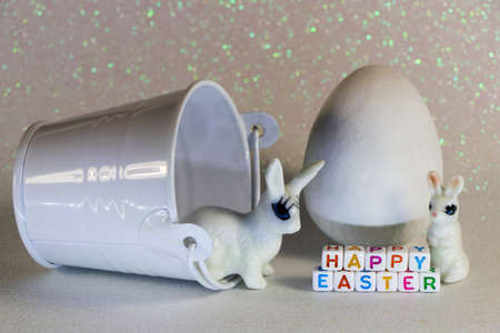 Happy Easter Bunnies With White Candy Egg And Bucket