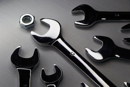 Chrome Spanners With Metal Hex Nut On White Surface