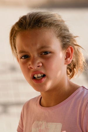 Young girl with disgusted look on her face