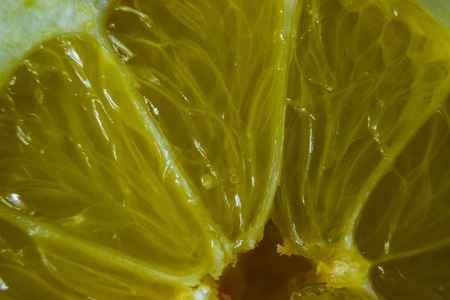 In the background is illuminated detail of sliced lemon.の写真素材
