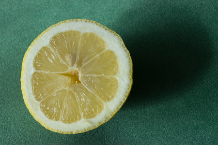 In the background is illuminated lemon cut in half.の写真素材