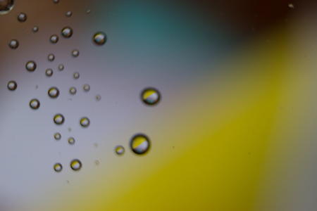 Beautiful drops colorful bokeh blurred defocused dots soft lights background with selective focus.の写真素材