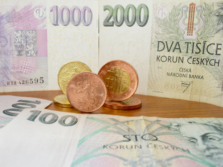 Czech coins on the various Czech banknotes money like background.