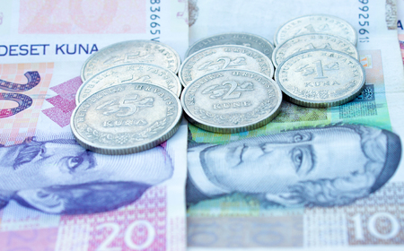 Croatian coins on the various Croatian banknotes money like background.