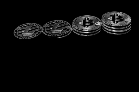 On a black background with free text space are silver coins of a digital crypto  currencies - Litecoin and Bitcoin.の写真素材