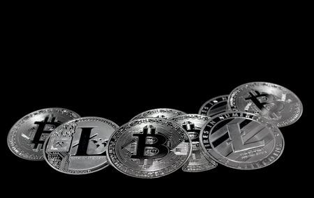 On a black background with free text space are silver coins of a digital crypto  currencies - Litecoin and Bitcoin.の写真素材