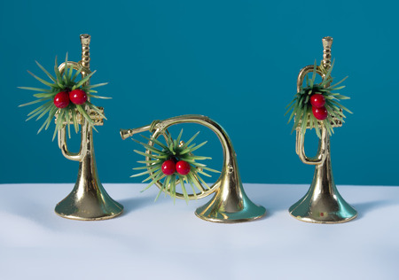 The two trumpets and horn festively decorated with a blue background. Christmas still life for musicians.の写真素材
