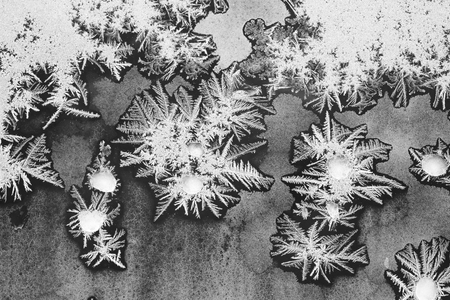 Colorful background with silver frost on a needle-shaped window. Frozen water on the window creates silver beautiful odecoration ornaments.の写真素材