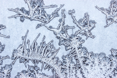 Frost creates various ornaments resembling human figures on the window