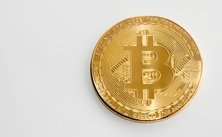 On a white background with free space for text is isolated gold coin of a digital crypto  currency - bitcoinの写真素材
