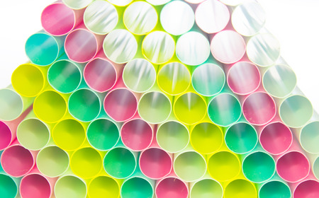 Many colorful straws stacked on top of each other.の写真素材