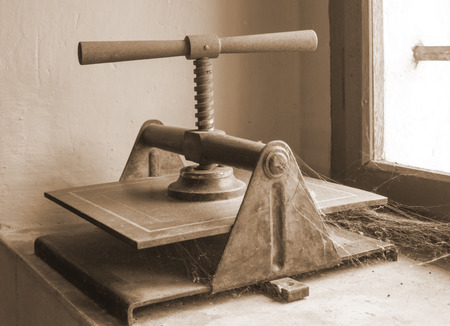 Retro book on window with spider web in sepia color
