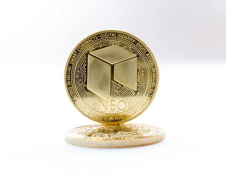 On a gray background are coins of a digital crypto  currencies - neo. In addition to the lying coin, there is standing neo.の写真素材