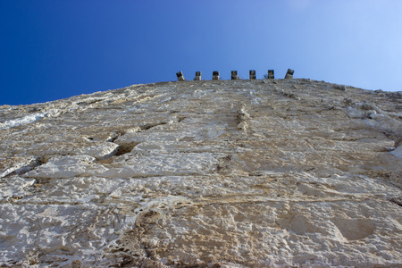 Detail of a stone wall. Bottom view. Blue sky.の写真素材