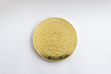 On a white background is isolated gold coin of a digital crypto  currency iota. The back side of the gold coin iota.の写真素材