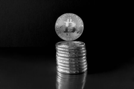 On a black background with free text space are silver coins of a digital crypto  currencies - Bitcoin. In addition to the lying coins, there are standing bitcoinの写真素材