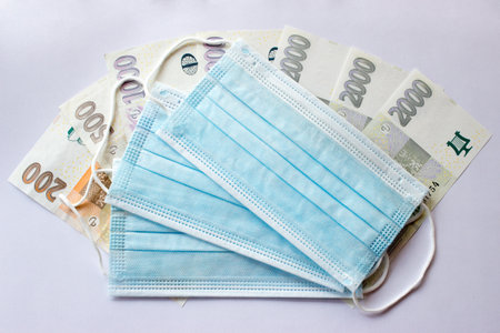 Still life masks are placed on banknotes of the czech crown - business moneyの写真素材