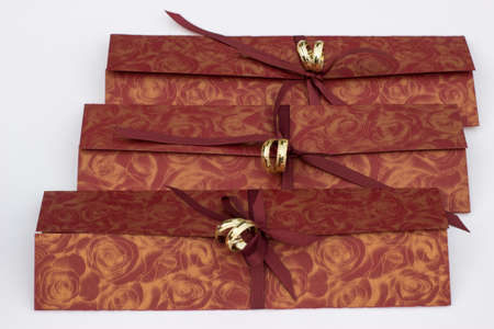 Wedding invitations with gold wedding decorative rings on a white backgroundの写真素材