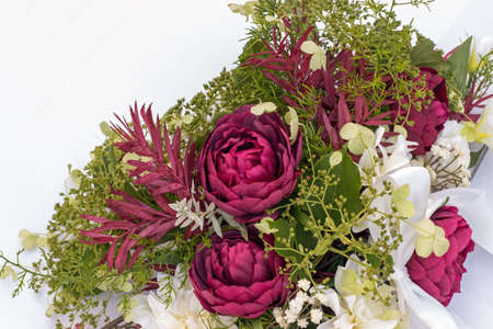 wedding bouquet on the car with ribbon on a white backgroundの写真素材