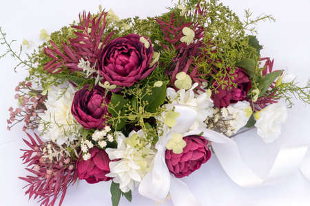 wedding bouquet on the car with ribbon on a white backgroundの写真素材