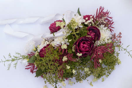 wedding bouquet on the car with ribbon on a white backgroundの写真素材