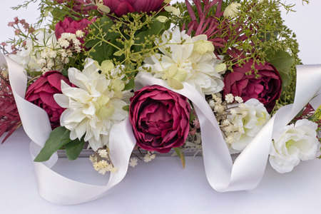 wedding bouquet on the car with white ribbonの写真素材
