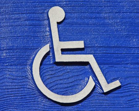 Close Up of Standard Hadicapped Parking Symbol Carved in Wood の写真素材