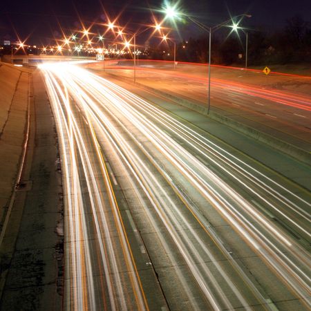A prolonged time exposure of a highway at nightime