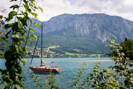 Sailboat on Attersee Lake with mountain view, Austriaの写真素材