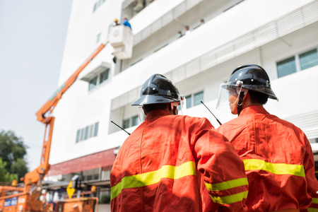 Firefighters or firemen are people whose job is to put out fires and rescue people. In a city, the building they work in is called a fire station, or fire hallの写真素材